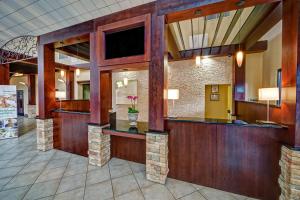 a lobby of a hotel with a reception desk and a tv at Holiday Inn Asheville - Biltmore West by IHG in Asheville