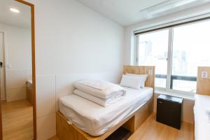Ein Bett oder Betten in einem Zimmer der Unterkunft Step Inn Myeongdong 1