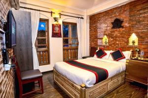 a bedroom with a bed and a brick wall at Newa Home in Kathmandu
