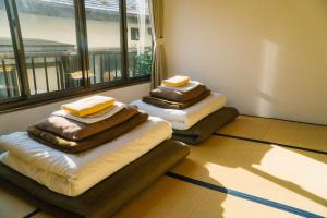 Postel nebo postele na pokoji v ubytování Onsen Guesthouse HAKONE TENT