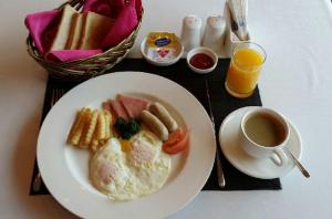 a plate of breakfast food with a cup of coffee at Prime Tourist Hotel in Busan