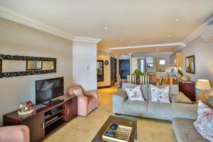 a living room with two couches and a tv at 504 Ballito Manor View-Luxury home on the main beach in Ballito