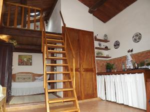 a room with a bunk bed and a wooden ladder at Sa Ruscitta in SantʼAntìoco