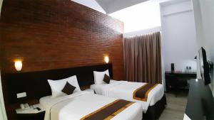 Postel nebo postele na pokoji v ubytování Xtra Hotel Bengkulu