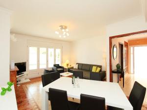 a living room with a table and a couch at Holiday Home Requesens by Interhome in Empuriabrava