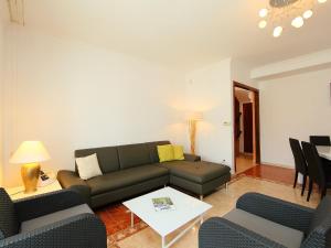 a living room with a couch and a table at Holiday Home Requesens by Interhome in Empuriabrava +17 photos