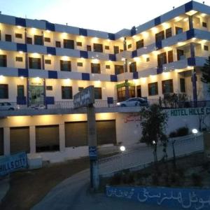 een groot gebouw met een straatbord ervoor bij Hotel Hill City Mingora Swat in Mām Derai