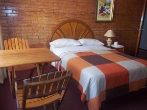Ένα ή περισσότερα κρεβάτια σε δωμάτιο στο Hotel Excalibur