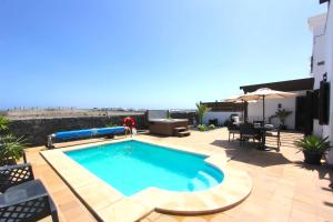 a swimming pool on the roof of a house at Villa Emma Playa Blanca in Playa Blanca