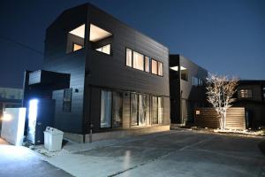 a black house with a driveway in front of it at TOCORO. Mt. Fuji Yayoi in Fujikawaguchiko