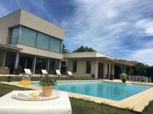 eine Villa mit einem Pool und einem Haus in der Unterkunft Villa de Lujo en Campo de Golf Peralada in Peralada
