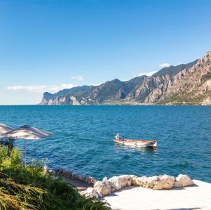 a boat in the middle of a large body of water at Villa Tempesta in Nago-Torbole