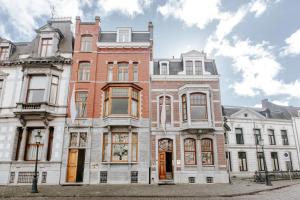 a large brick building on a city street at Maison Haas Hustinx & Spa in Maastricht