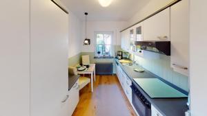 a kitchen with white cabinets and blue counter tops at Ferienwohnung Sonnenschein in Goslar