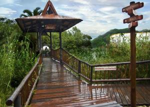 a wooden walkway with signs on the side of it at Claridges 302 in Margate