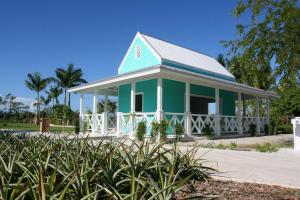 a blue and white house with a white porch at Holiday Inn Express & Suites Naples Downtown - 5th Avenue by IHG in Naples