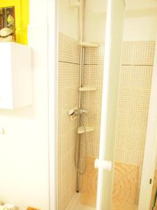 a shower in a bathroom with a glass door at LA PLAGE 30A in Roses
