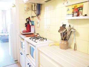 a small kitchen with a stove and a sink at LA PLAGE 30A in Roses