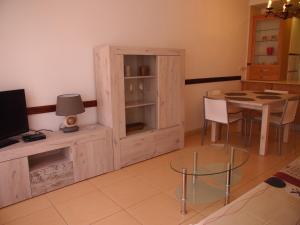 a living room with a wooden cabinet and a table at ROSES 4 in Roses