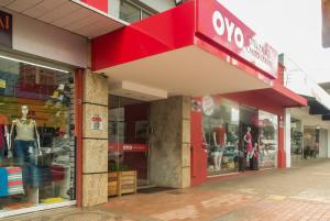 a store with a red sign on the front of it at Palace Hotel Campo Grande in Campo Grande