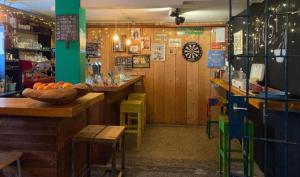 a restaurant with a counter with a bowl of oranges on it at Hostel Roots in Tilburg