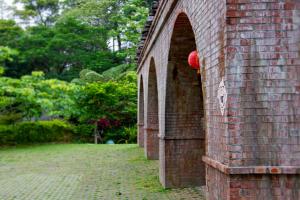 a brick wall with a red ball on it at Futen Villa in Sanyi
