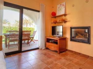 a living room with a tv and a fireplace at Holiday Home Ducados Golf by Interhome in Pals