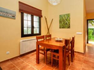 a dining room with a wooden table and chairs at Holiday Home Ducados Golf by Interhome in Pals