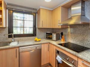 a kitchen with a sink and a microwave at Holiday Home Ducados Golf by Interhome in Pals