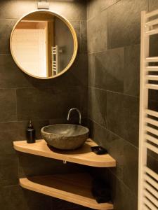 a bathroom with a bowl sink and a mirror at Le Chalet de Juliette in Besse-et-Saint-Anastaise +13 photos