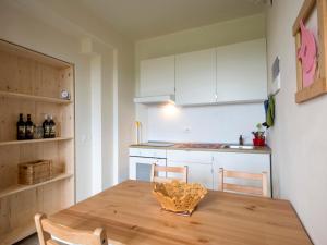 a kitchen with a wooden table and two chairs at Apartment Il Venturino-2 by Interhome in Fucecchio