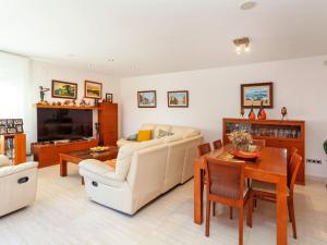 a living room with a couch and a table at Holiday Home Lumiere by Interhome in Sant Antoni de Calonge