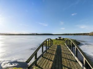 a dock on a lake with a picnic table on it at Holiday Home Viljami by Interhome in Kaustinen