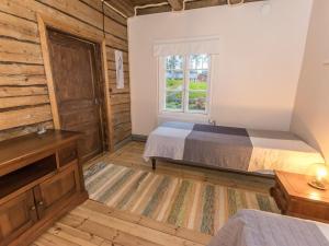 a bedroom with a bed and a window at Holiday Home Nybyggningen by Interhome in Björkboda