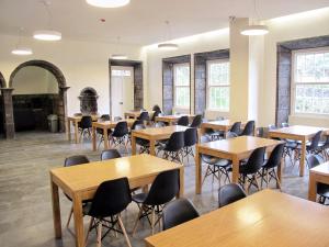 a classroom filled with tables and chairs at Azores Youth Hostels - Sao Miguel in Ponta Delgada