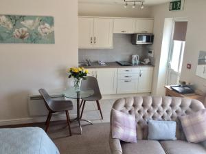 a living room with a couch and a table at Ramsley Fields Apartments, Melbourne View in Melbourne