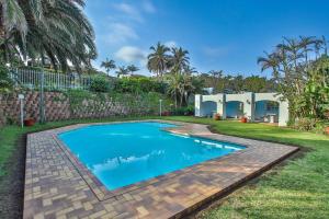 a swimming pool in the yard of a house at 4 Skiathos-family holiday home with breaker views in Ballito