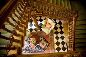 a stairway with a table and chairs on a rug at Middlethorpe Hall & Spa in York