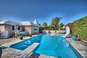 a swimming pool with a slide next to a house at Beach Walk Cottage in Mount Pleasant