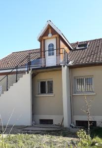 a house with a balcony on top of it at Gîte Les Chevaliers fous in Sainte-Menehould +7 photos