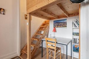 a tiny room with a desk and a ladder at Le Denfert, 40m2 avec vue in Grenoble