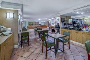 a restaurant with tables and chairs in a room at La Quinta Inn by Wyndham San Antonio I-35 N at Rittiman Rd in San Antonio