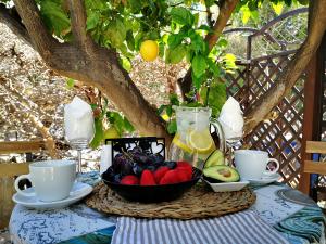 a table with a bowl of fruit on it at Tedy's Townhouse-Margarita Gardens in Paphos City