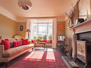 a living room with a couch and a fireplace at Myrtle House Penzance in Penzance