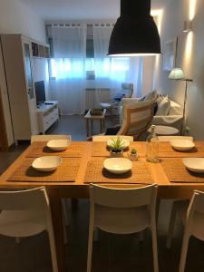a dining room table with chairs and a living room at Fantastic apartment a few meters from the beach in the center of Estartit in L'Estartit