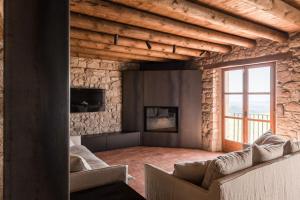 a living room with couches and a large window at La Baumeta in San Mauricio