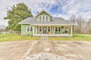a green house with a driveway in front of it at Elegant and Spacious Retreat about 18 Mi to Lake Norman! in Lincolnton