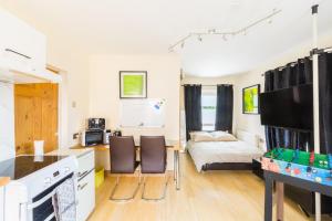 a kitchen and living room with a bed and a table at Umbrella Properties Private Apartment Birmingham in Birmingham