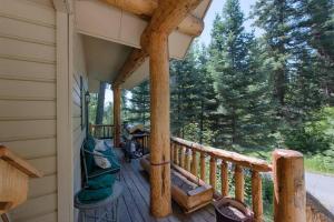 a porch of a cabin with a view of trees at Sharlie's Nest by Casago McCall - Donerightmanagement in McCall