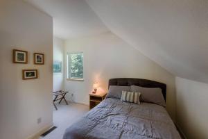 a bedroom with a bed and a desk and a window at Sharlie's Nest by Casago McCall - Donerightmanagement in McCall